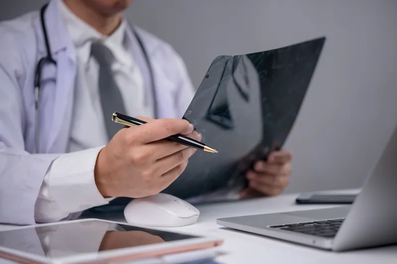 Colorectal specialist assessing patient’s X-ray report