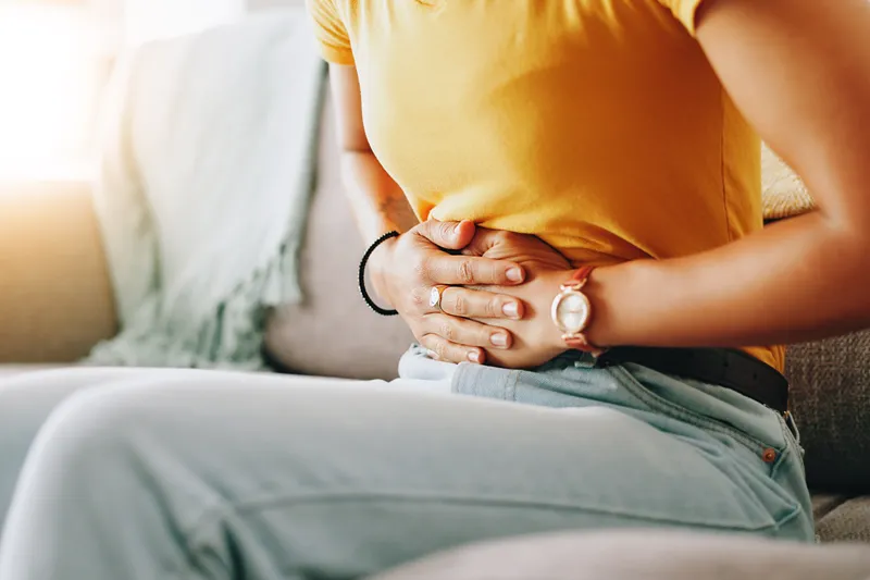 Woman experiencing abdominal pain
