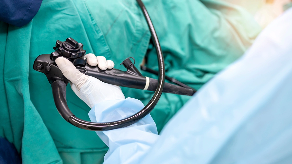 Doctor dressed in sterile protective gear before conducting a colonoscopy procedure.