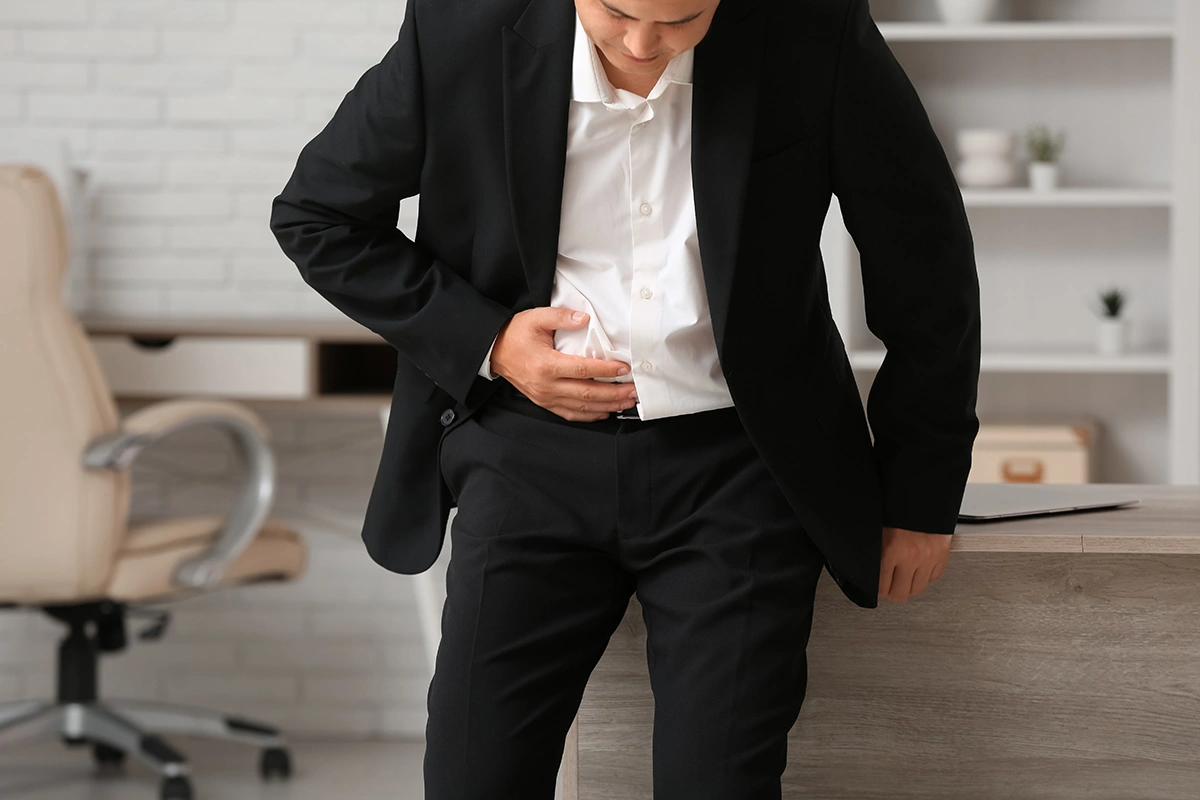 Man suffering from appendicitis with severe lower abdominal pain.